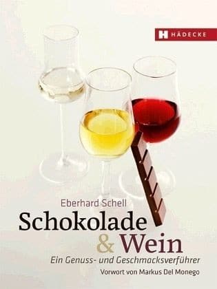 Neuauflage „Schokolade und Wein“ zeigt drei Gläser mit Wein von rot bis weiß. An das mittleren Glas lehnt ein Riegel Schokolade, darunter steht der Titel " Eberhard Schell, Schokolade und Wein, Ein Genuss- und Geschmacksverführer, Vorwort von Markus Del Monego