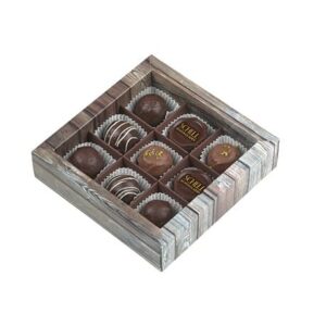 9er Schachtel "Essigschleckerle" von Schell Schokoladen ist mit neun Essigpralinen (Riesling Schleckerle, Lemberger Schleckerle, Balsam Schleckerle, Müller-Thurgau Schleckerle) gefüllt in einer Schachtel die aussieht wie Holz.